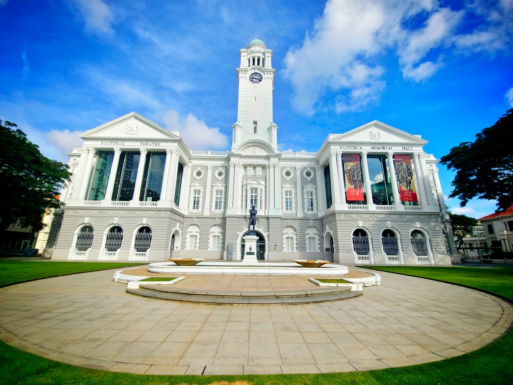 Colonial buildings in Singapore’s Civic District, including the National Gallery and Victoria Theatre under blue skies
