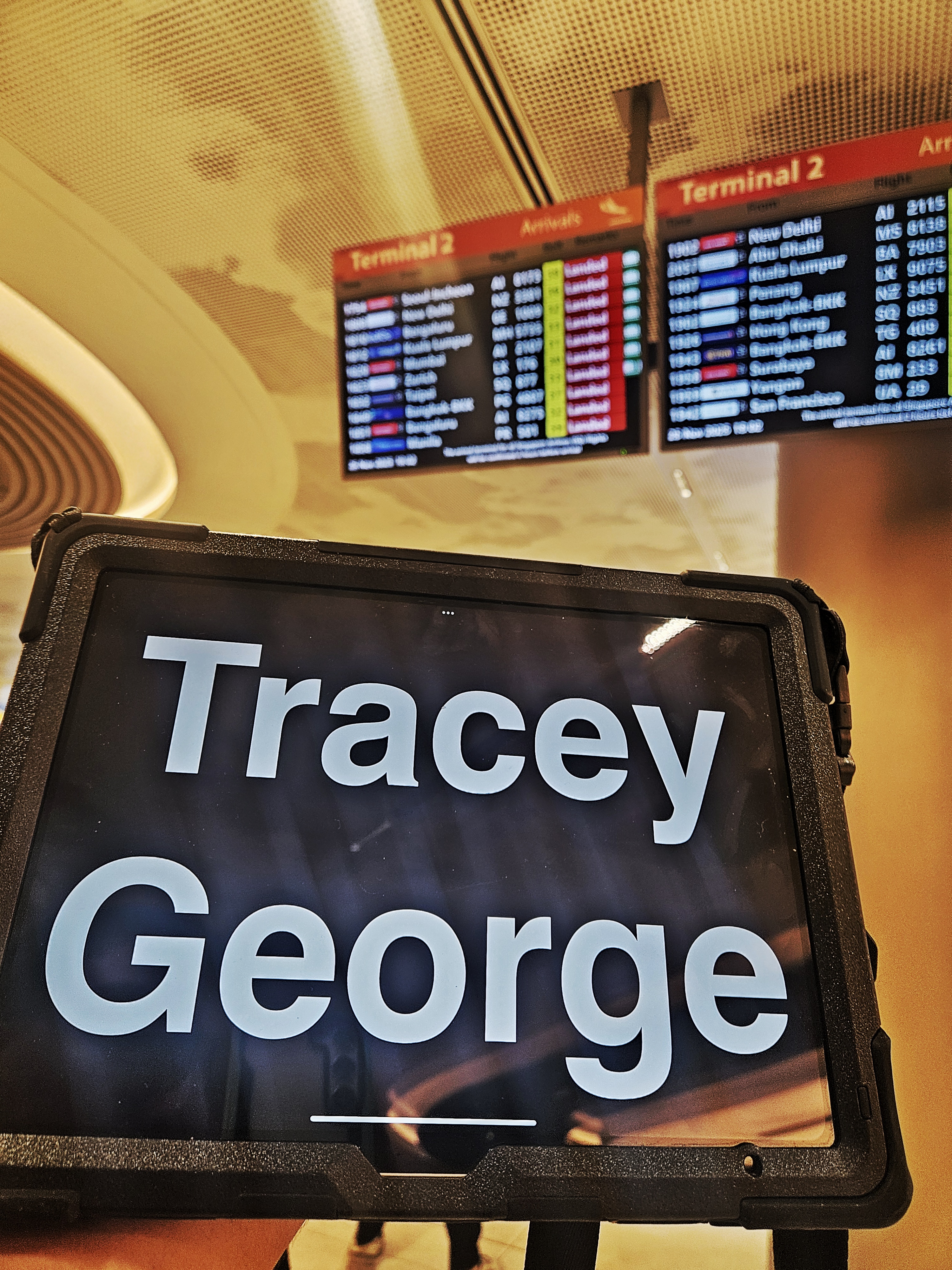 Personal airport pickup with tablet signage at Changi Airport